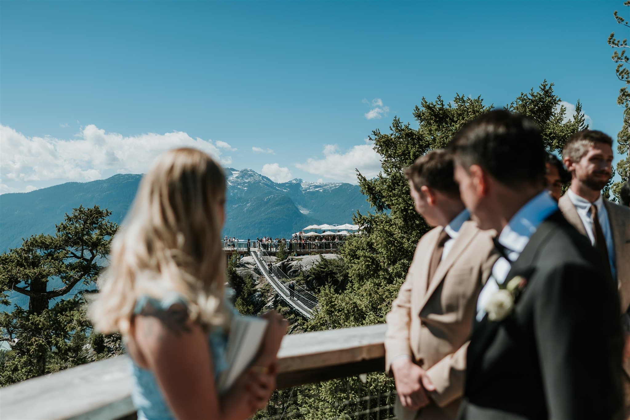 Groom watches Bride walk the suspension bridge at the Sea to Sky Gondola in Squamish BC